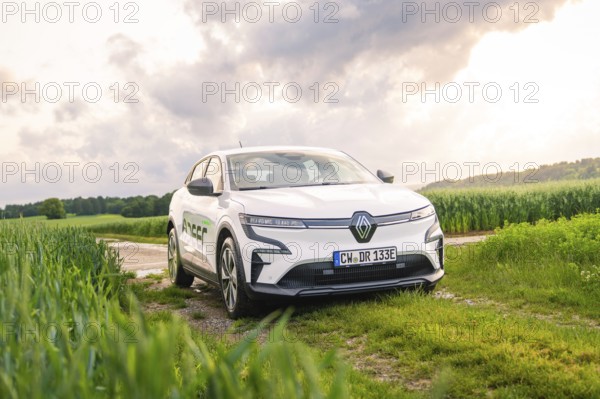 A white Renault vehicle parked on a dirt track under a cloudy sky, Deer E- CarSharing, Renault