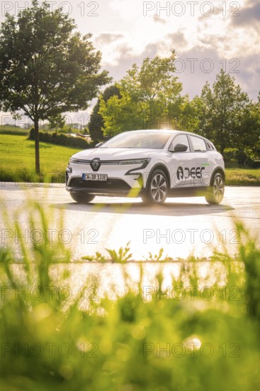 White car on wet road, sun rays reflecting, rural environment, Deer E- CarSharing, Renault Megane