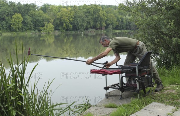 Fisherman, Angler prepares fishing rod for fishing, South Hungary, Hungary, South Hungary, Hungary