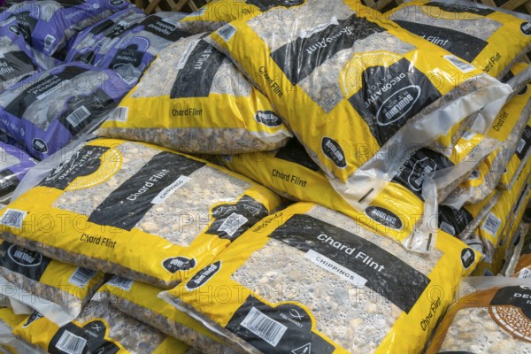 Chard Flint stone chippings bags stacked up at Lowden garden centre, Wiltshire, England, UK