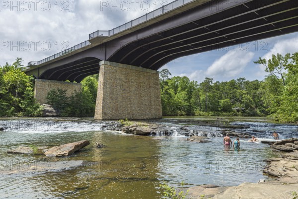 People playing on the rocks under the Little River Falls Bridge in Little River Canyon Falls Park