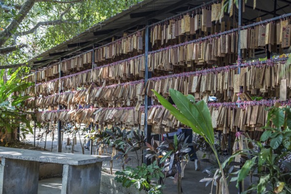 Plaques with messages from prrevious customers hang at entrance to the Akha Cottage restaurant and