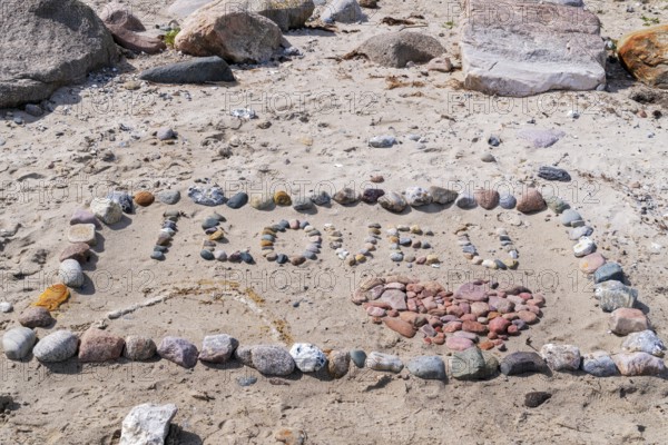 I Love You with heart on the beach with stones in the sand