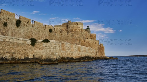 Castello Maniace, sea fortress Maniace, historic fortress on the water, striking under a clear blue
