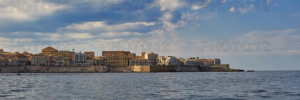 Historic city scenery on the coast under a slightly cloudy sky, boat trip around the island of