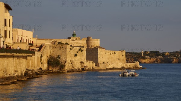 Castello Maniace, Maniace sea fortress, Mediterranean landscape with historic buildings and boat in