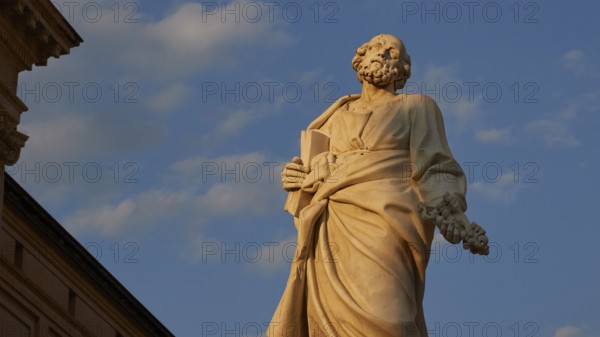 Cathedral of Syracuse, detail of a statue in front of a blue sky, part of a historic building,