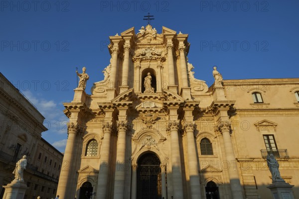 Cathedral of Syracuse, Magnificent facade of a cathedral in warm sunlight with detailed columns,