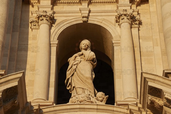 Cathedral of Syracuse, detail of a sculpture on the façade of a historic building with columns,
