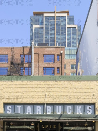 Starbucks sign on a wall of the oldest Starbucks from 1971 on Pike Place Market, Seattle,
