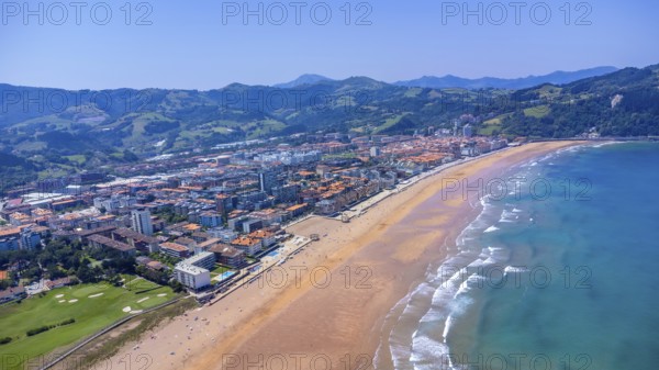 Aerial view of zarautz, gipuzkoa, showcasing the urban area meeting a golden sandy beach, with