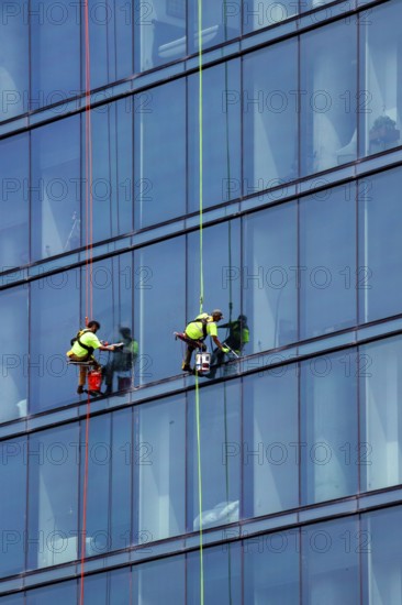 Detroit, Michigan - Window washers at the 25-story Residences Water Square luxury apartment