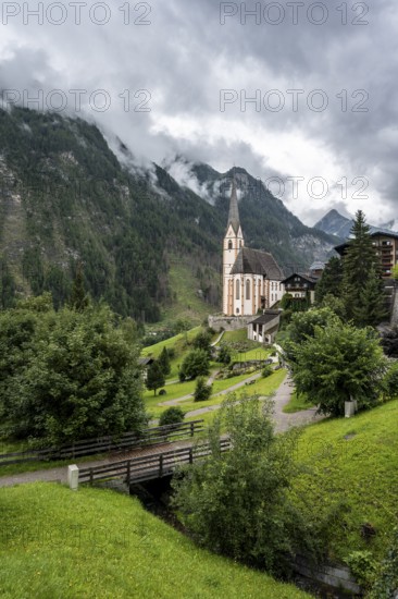 Parish church of St Vincent in Heiligenblut, cloudy mountain landscape, courtyard, Heiligenblut am