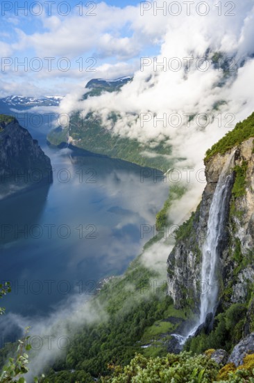 Gjerdefossen waterfall, at Ørnesvingen viewpoint, atmospheric clouds over the fjord in the morning