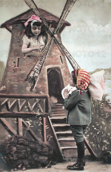 Children's windmill, miller, ca. 1910, Two children play a scene at a windmill in colourful