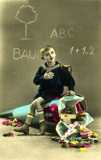 Child giant school cone, 1930s, boy sitting on a fallen school cone in front of a blackboard, toys