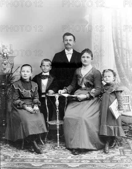 Father Mother Boy Girl, 1920s, A formal family portrait with parents and three children in