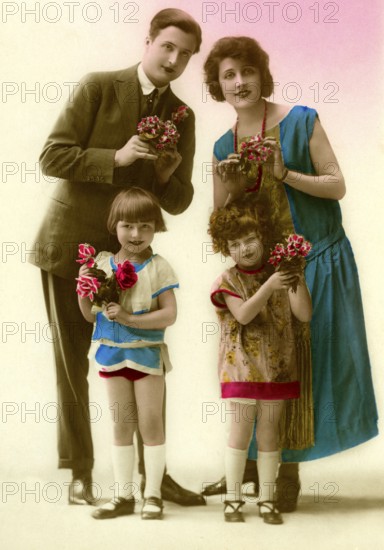 Family with flowers, 1930s, Family portrait with flowers in colourful clothes, smiling and posing,