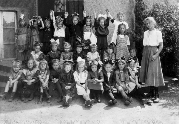 Group of girls in the 1930s, ca. 1930, A large group of children and a teacher are happy and posing