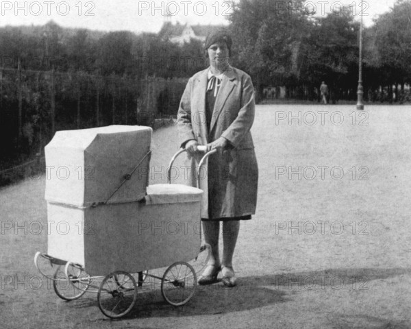 Woman with pram, 1930s, Woman with pram in a park, historical black and white photo with vintage