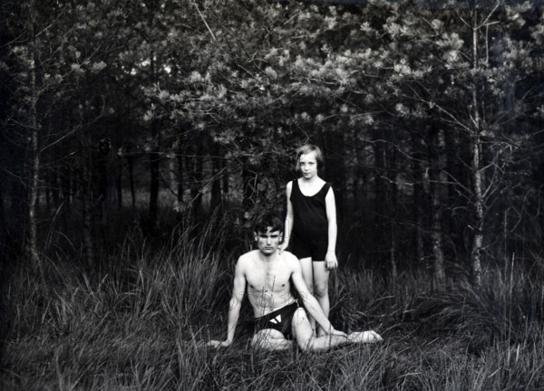 Brother and sister in swimming costumes, 1930s, Two people in swimming costumes in a forest, one