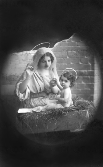 Mary and Jesus with halo, 1930s, Religious depiction of a woman with a halo holding a child, as in
