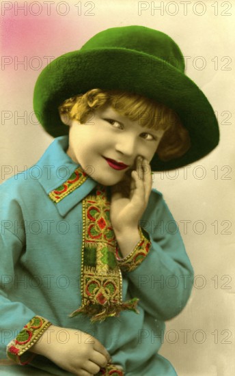 Girl with green hat, 1920, boy in green hat and blue shirt smiling and looking to the side,