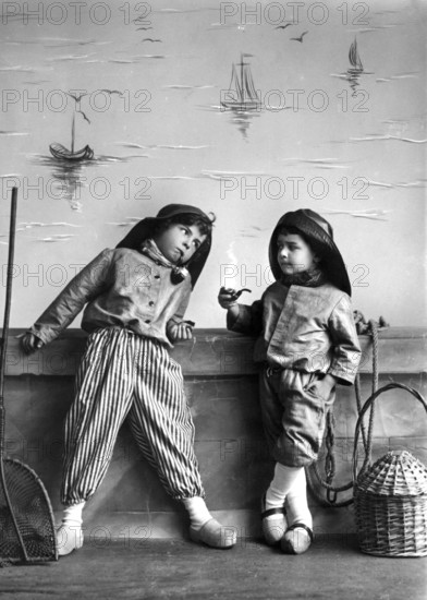 2 Dutch boys with pipe, 1920, Two boys in fantasy costumes, a little bit turned on, with sailing