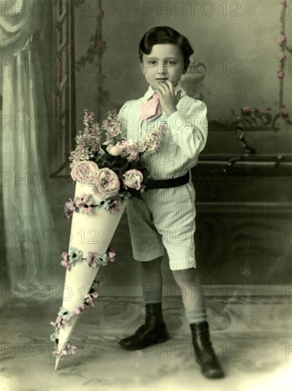 Boy with school cone, 1930s, A little boy in a suit with a large, decorative bouquet of flowers,