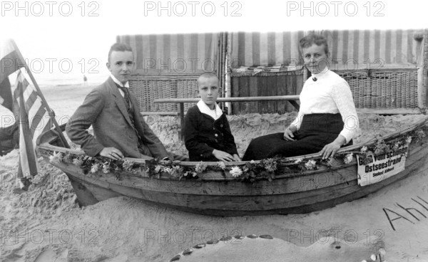 Family in a boat, beach, Baltic Sea, 1930s, Family sitting in a small boat on the beach, Historical