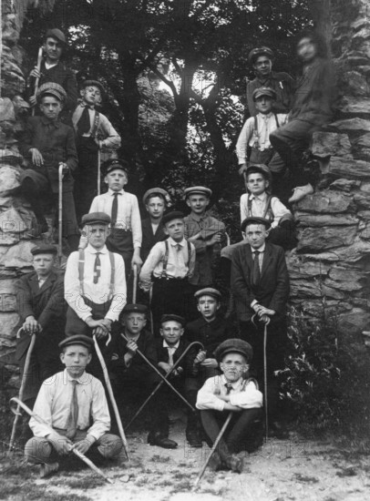 Group photo, 1920s, Group of boys in historical surroundings with walking sticks, Black and white
