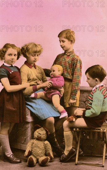 2 boys 2 girls, 1920s, Five children playing together with a doll in a nostalgic setting,