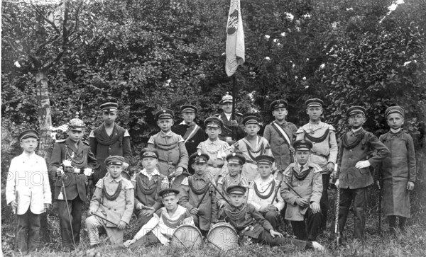 Children soldiers, 1920s, group of boys in uniform posing together outdoors, black and white,