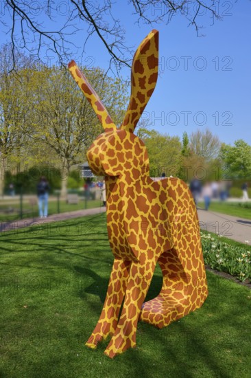 Bunny sculpture with pattern in a park under a blue sky, Keukenhof, Lisse, province of South