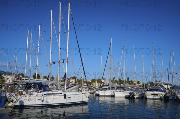 A harbour full of sailing boats and yachts against a clear blue sky, Marina, Kos Town, Kos,