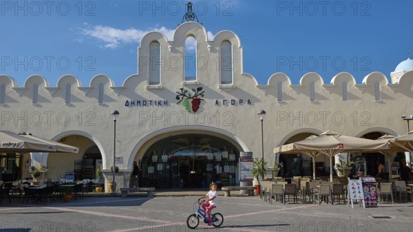 Traditional market square with iconic architecture and playing child, Agora, Market Hall, Kos Town,