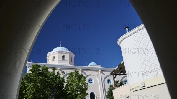 View of a sacred church with dome through an arch under a clear sky, Agia Paraskevi Church, Kos