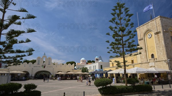 Public square with cafés and striking architectural elements under a blue sky, Eleftherias Square,
