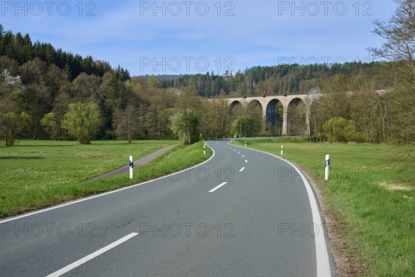 A winding road leads to a viaduct in a wooded landscape, spring, Obersinn, Sinntal, Spessart,