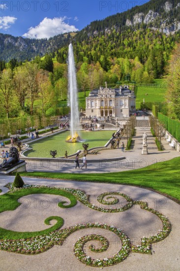 Water parterre with large fountain and portal of Linderhof Castle in spring, municipality of Ettal,