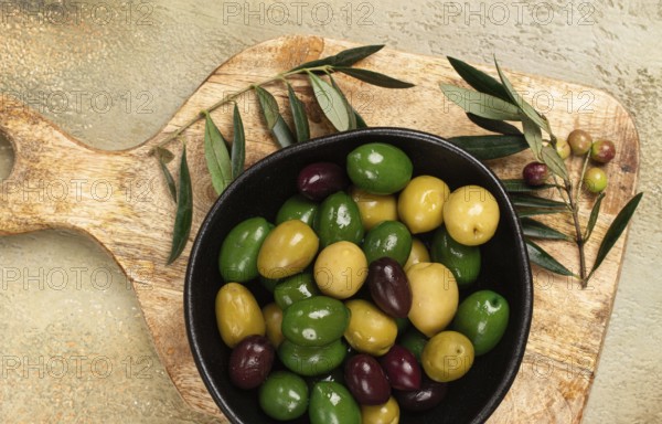 A mixture of olives, varieties of chalkidiki, Verdi giganti and Kalamata, in a bowl, top view, no