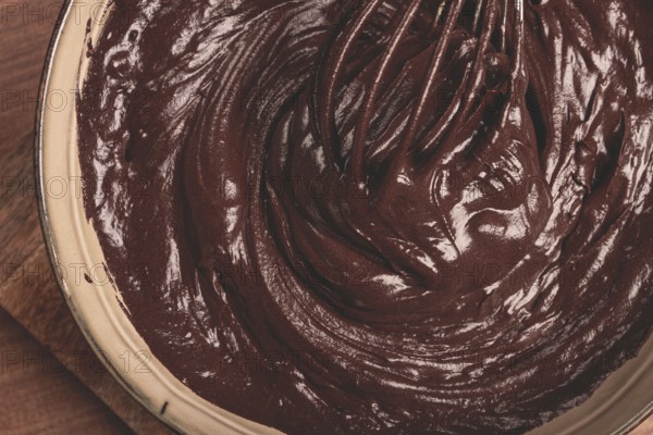 A bowl of chocolate dough, a whisk for whipping, baking, structure and consistency, homemade, top