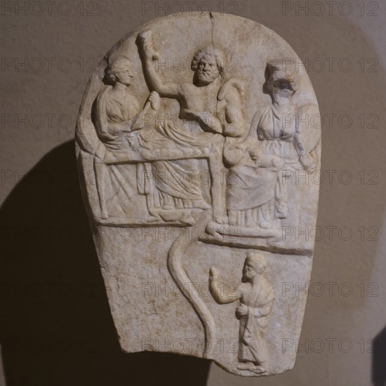 ©Udo Rein, Antique stone relief with several figures in scene, banquet of the dead, snake, Casa