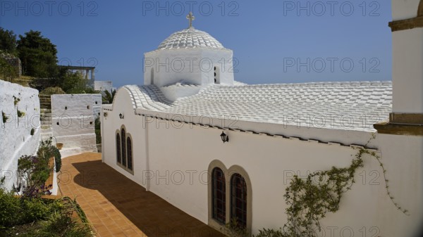 Cross-domed church Panagia Diasosousan, white church in Mediterranean style with dome and cross,