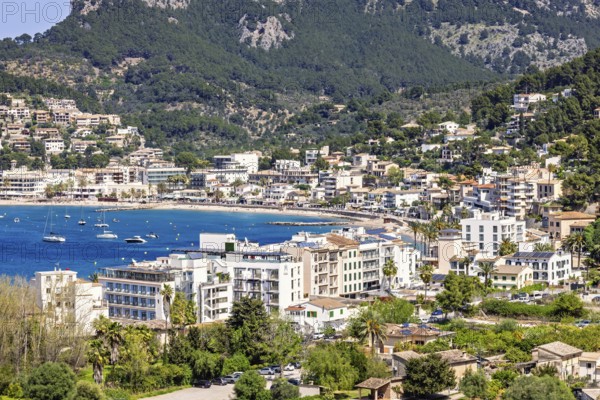View at a tourist resort with houses by a seabay and mountains in the summer, Sant Elm, Mallorca,