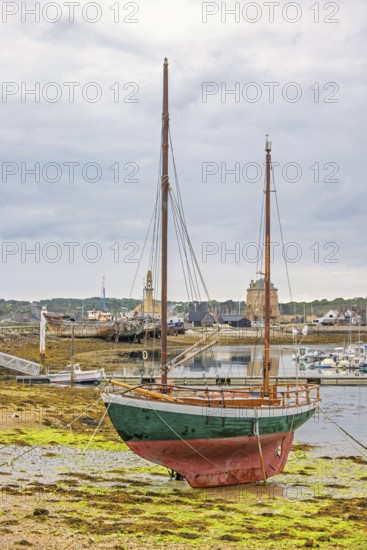 Old wooden sailboat on the beach in a harbour at low tide, Camaret-sur-Mer, Crozon peninsula,