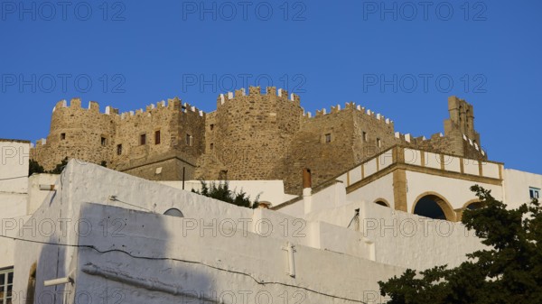 Majestic, historic castle above white buildings under a blue sky, Monastery of St John the