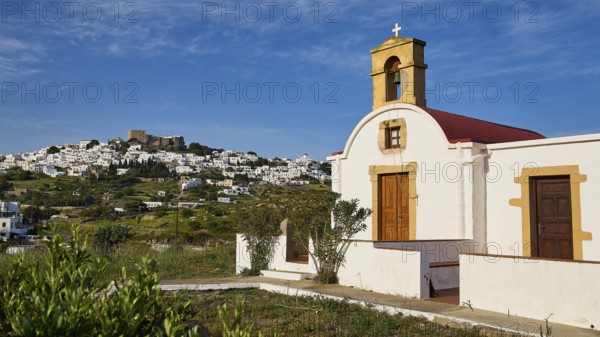 White chapel with a view of a village under a blue sky, chapel south of the Chora, World Heritage