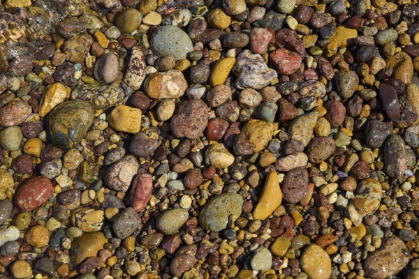 Colourful pebbles in a natural arrangement with different shapes and colours, Lambi Beach, Lambi