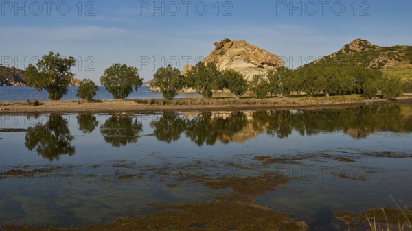 Rocks and trees reflected in a calm lake under a clear sky, Rocks of Kalikatsou, Seasonal Salt